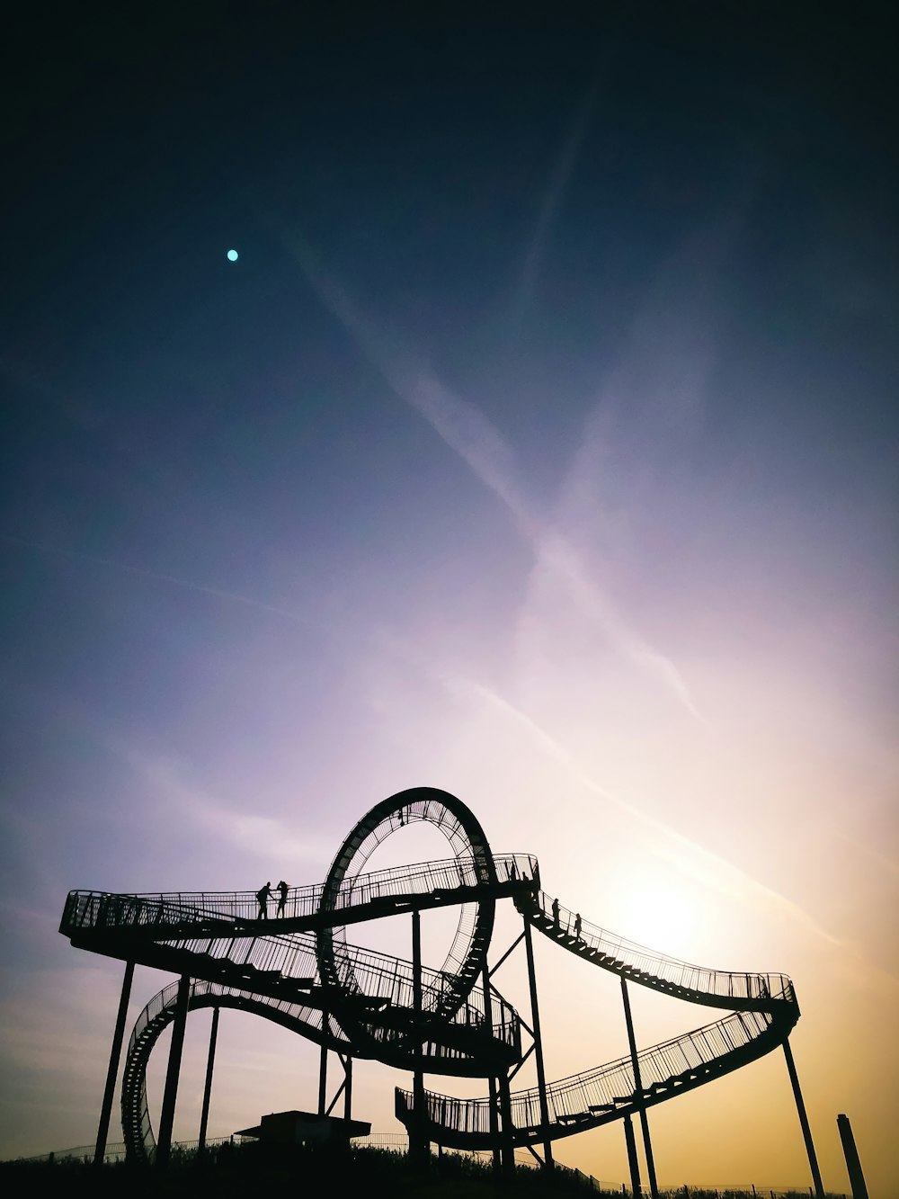 two person on top of roller coaster