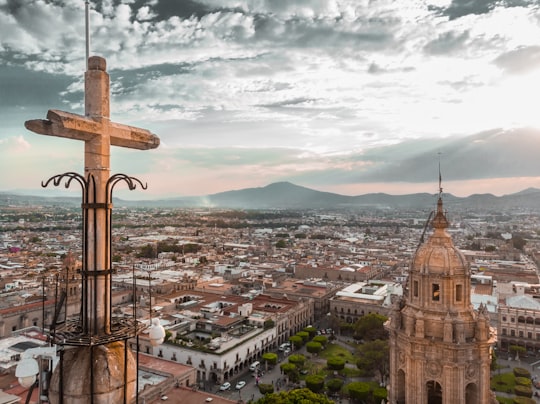 cathedral near houses during daytime in Morelia Mexico