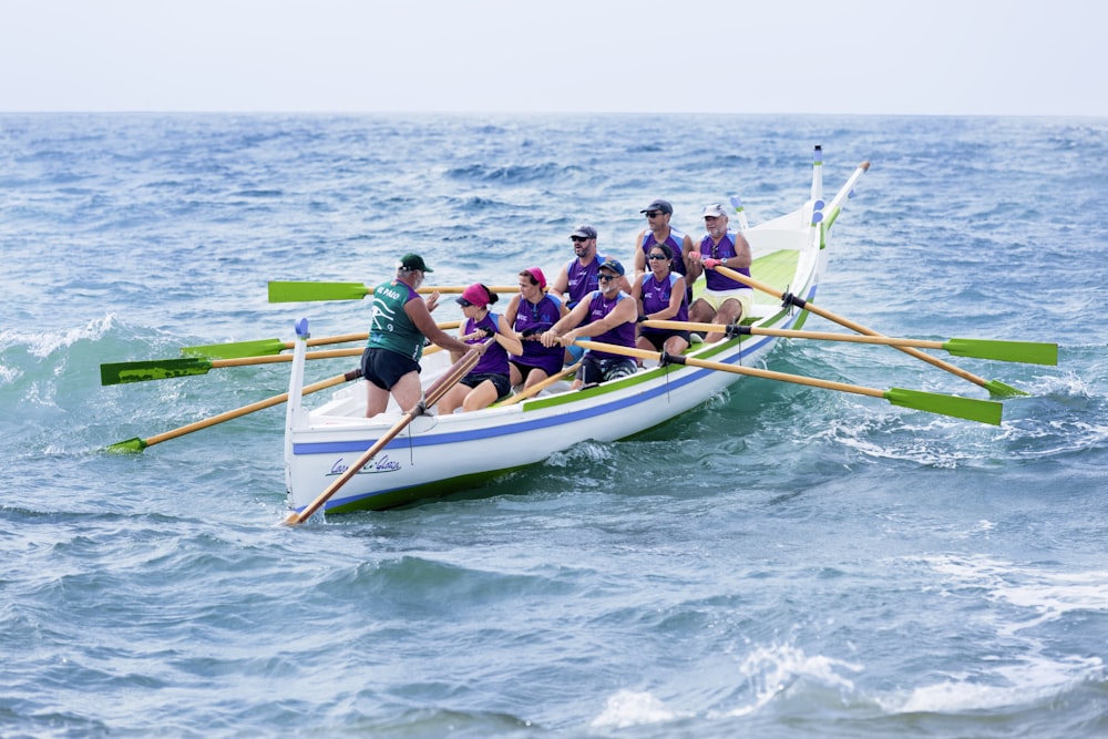 people paddling on sea