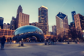 a group of people standing around a large metal object