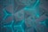 An array of three-dimensional geometric shapes featuring triangular pyramids arranged in a symmetrical pattern. The shapes have a glowing cyan outline, creating a futuristic and dynamic visual effect against a dark background.