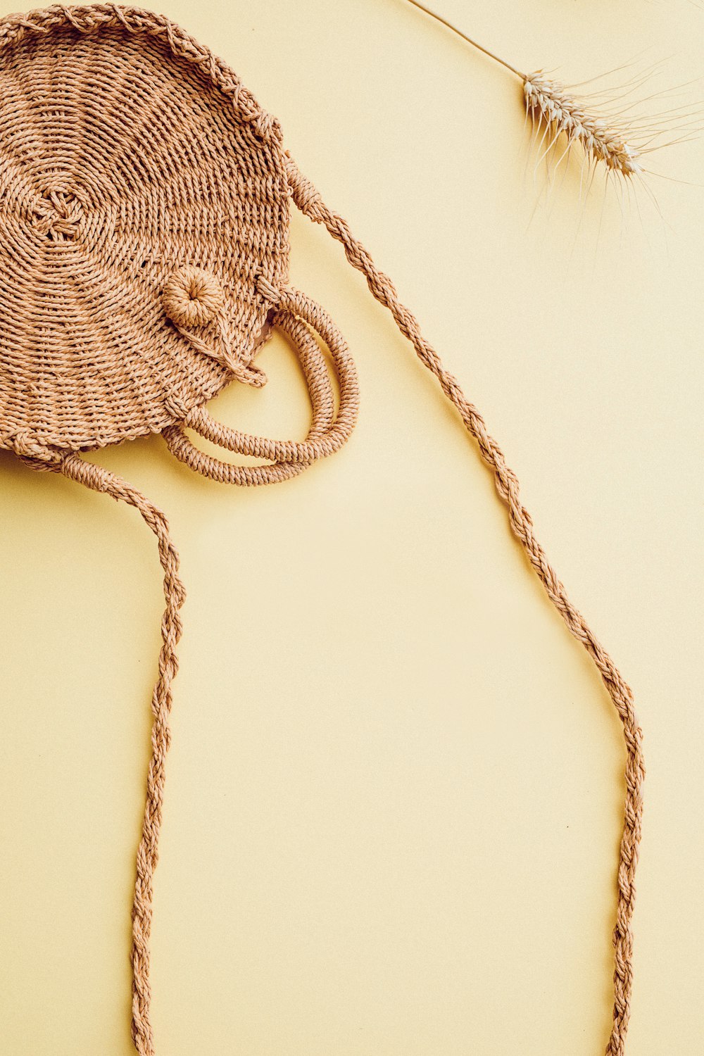 brown woven sling bag on table