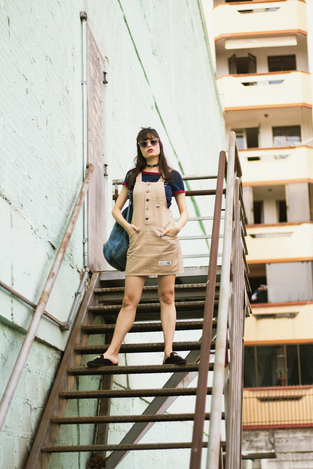 woman standing on stair beside door