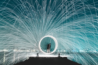 man standing on dock steel wool photography