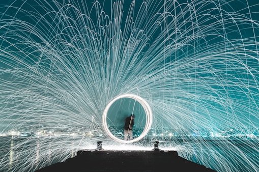 man standing on dock steel wool photography
