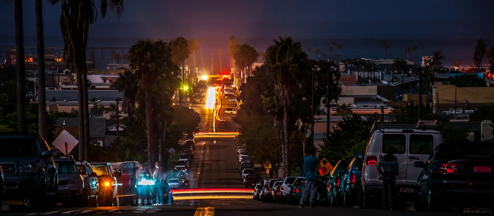 vehicles park on roadway during nighttime