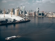 city across body of water under white clouds
