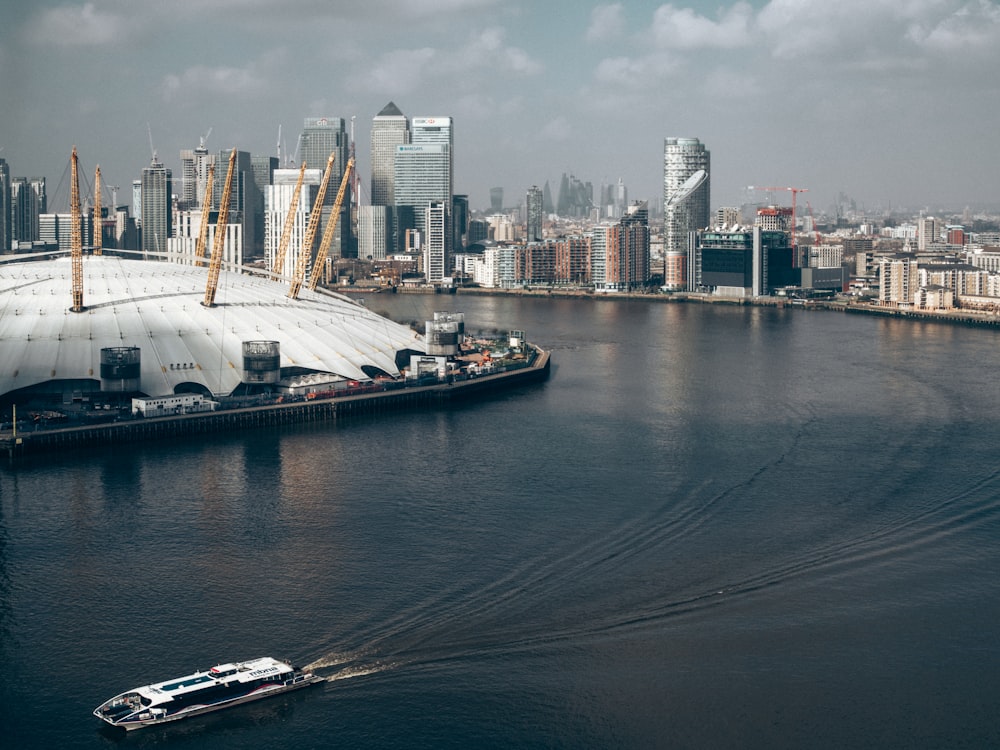 city across body of water under white clouds