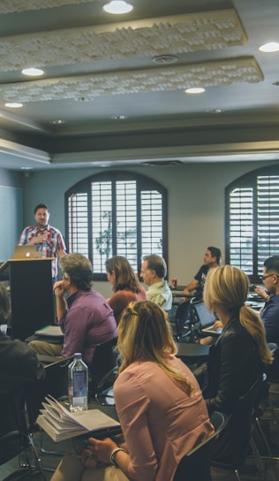 a group of people in a room with a projector screen