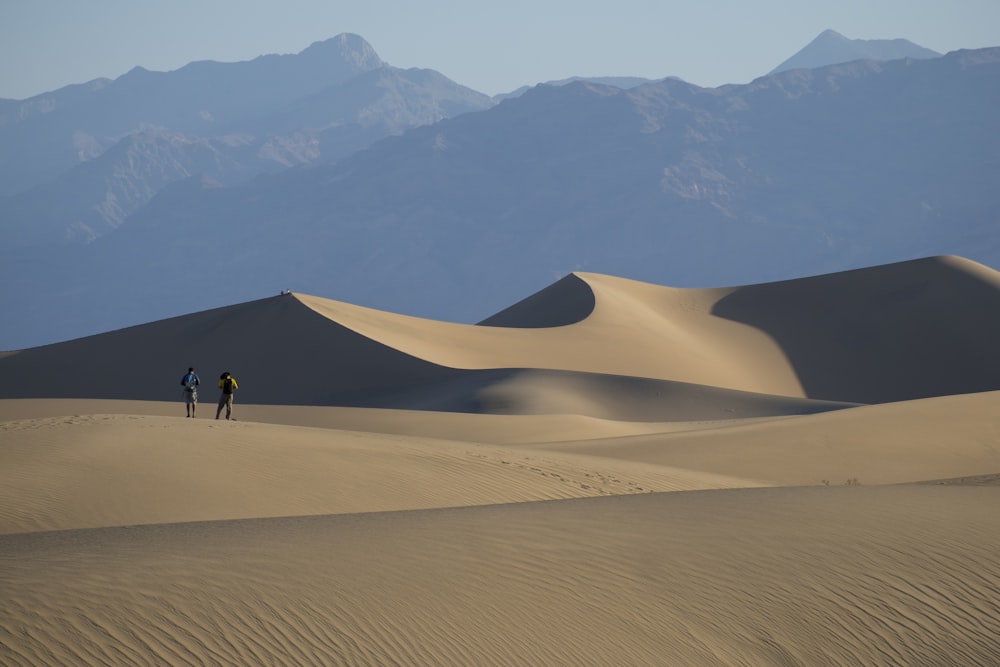 person in the middle of sand dunes