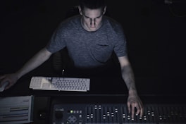 man in gray shirt using sound equalizer