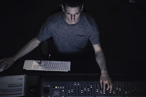 man in gray shirt using sound equalizer