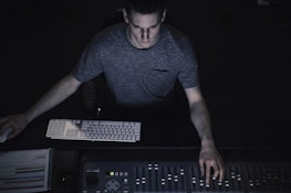 man in gray shirt using sound equalizer