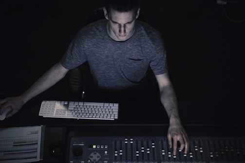 man in gray shirt using sound equalizer