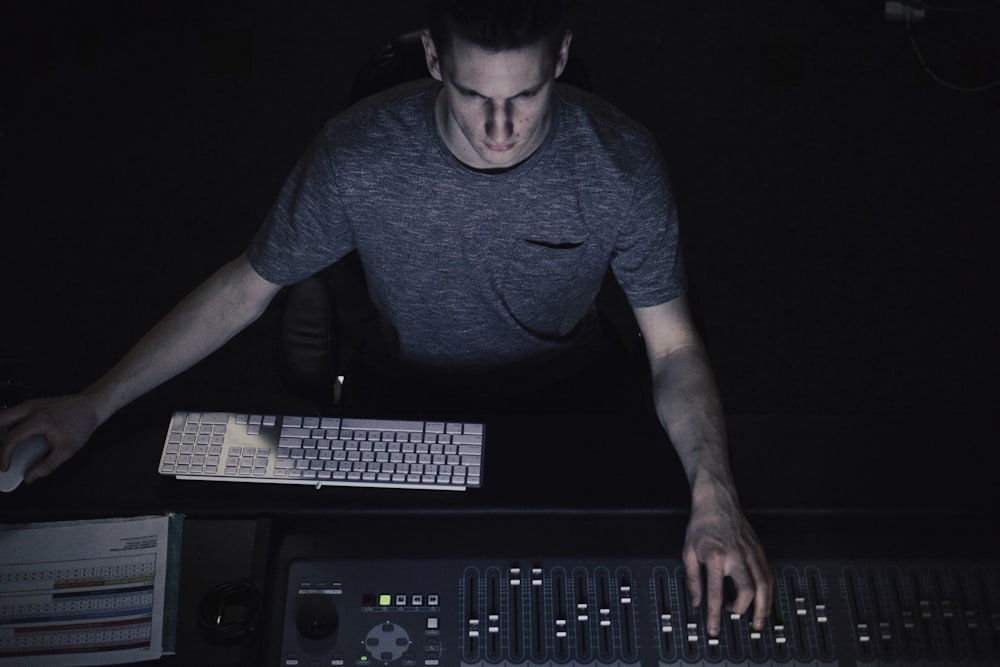 man in gray shirt using sound equalizer