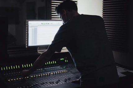 Close-up of a sound engineer working on audio mixing in a modern studio.