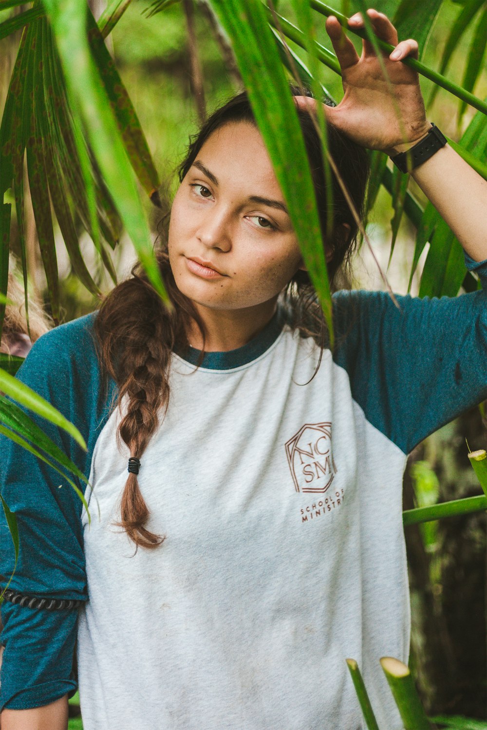 woman standing under plants