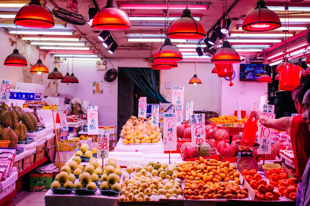 man standing near fruit stand