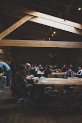 People collaborating in a bright coffee shop brainstorming startup ideas.