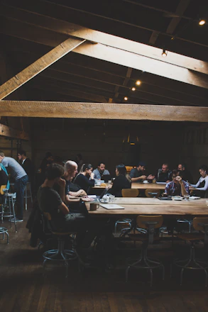 A warm, inviting community gathering where people share ideas over coffee.