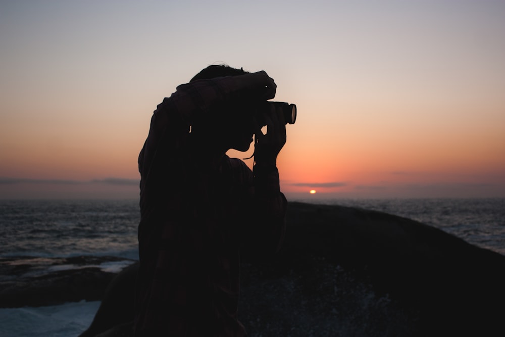 silhouette of person taking photograph
