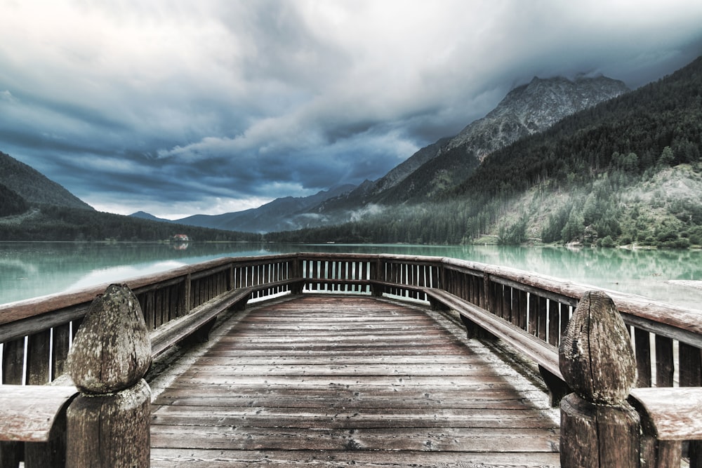 brown wooden dock facing mountains