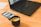 A close-up of a laptop displaying a visa application website with a cup of coffee beside it.