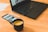 A close-up of a laptop displaying a visa application website with a cup of coffee beside it.