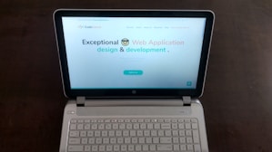 A sleek, modern business website homepage displayed on a laptop.