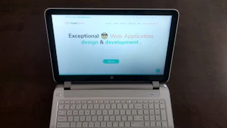 Clean and modern website homepage design on a laptop screen, showcasing a professional business site.