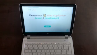 A clean, simple website layout displayed on a laptop screen.
