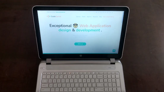 A laptop screen displaying a modern, colorful business website design.
