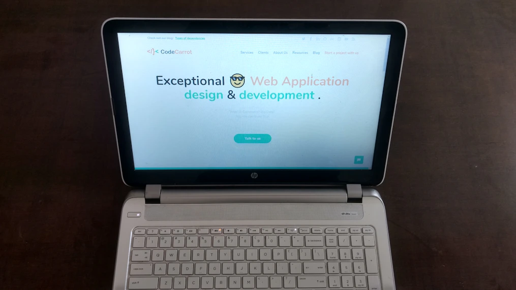 A sleek modern website homepage displayed on a laptop screen with vibrant colors and clean design.