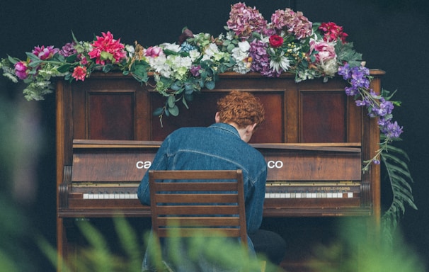 man playing upright piano