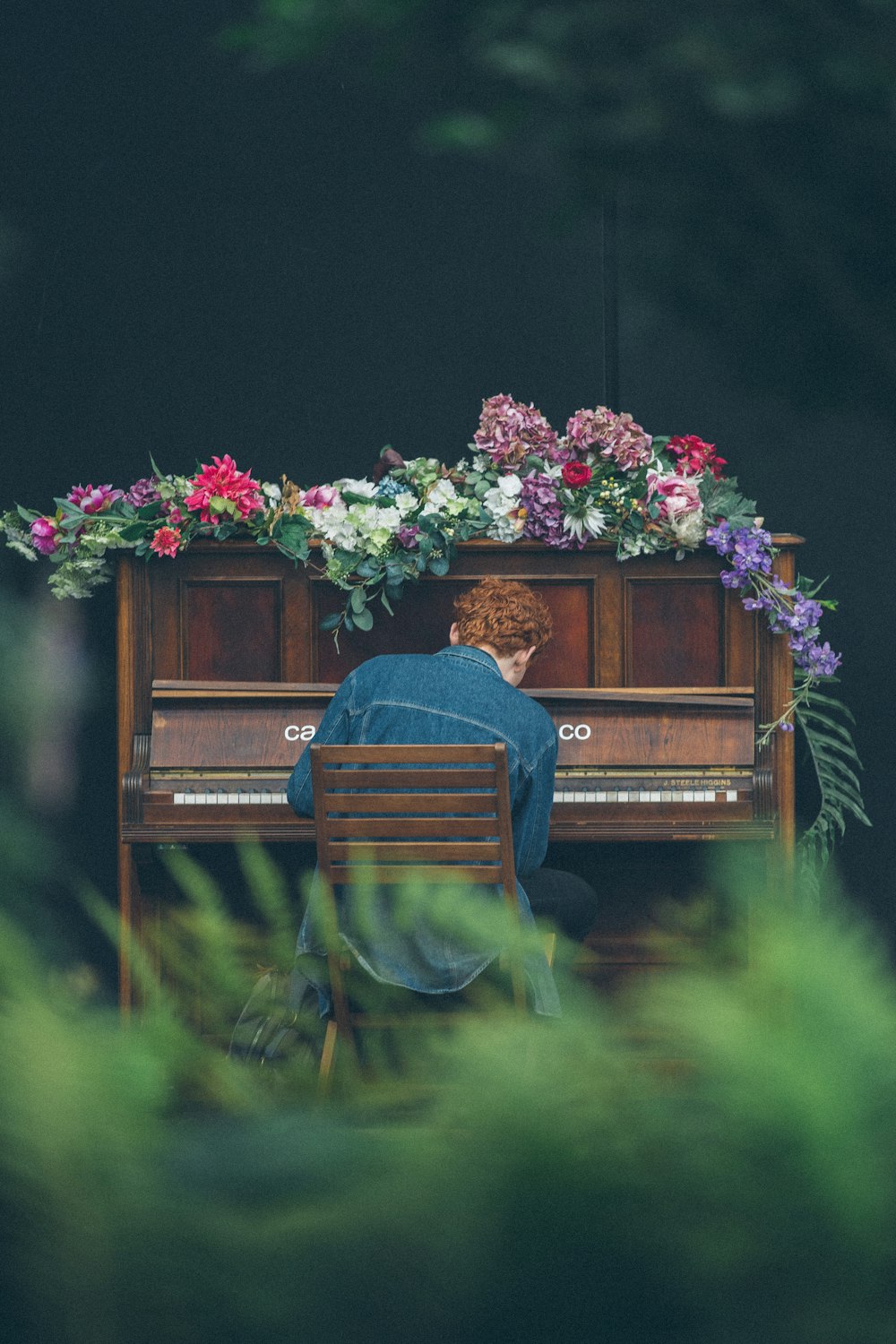 man playing upright piano