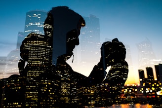 silhouette of man holding camera on glass window