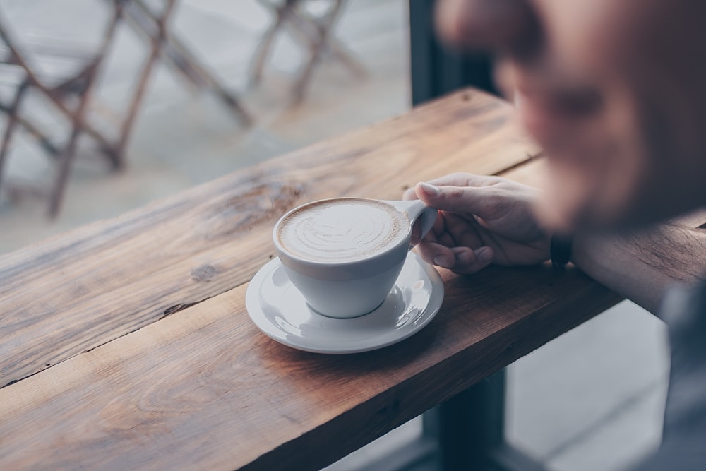 person holding teacup