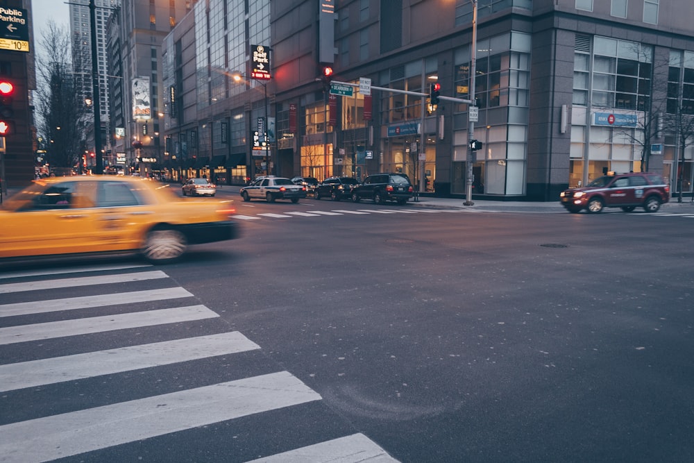 yellow car on white pedestrian lane