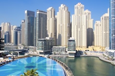 city buildings near in-ground pool during daytime