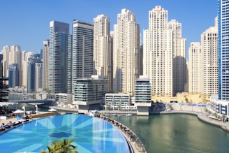 city buildings near in-ground pool during daytime