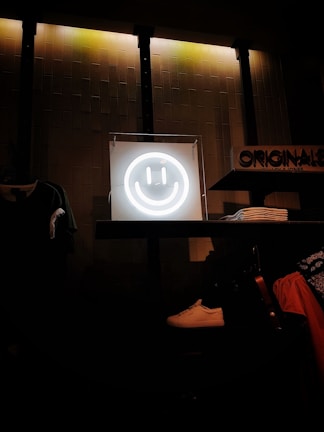 Smiling staff arranging promotional items on shelves with bright signage