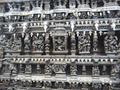 Close-up of ancient Norse carvings depicting wolves and mythic symbols.