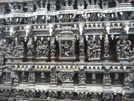 Close-up of ancient Norse carvings depicting wolves and mythic symbols.