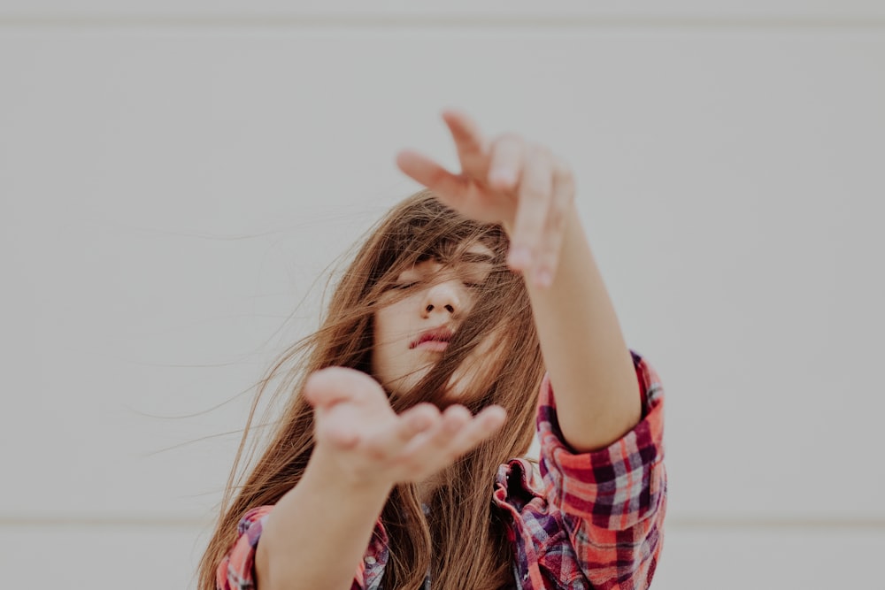 woman standing behind white background