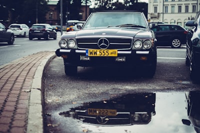 black mercedes-benz car on parking old-fashioned teams background