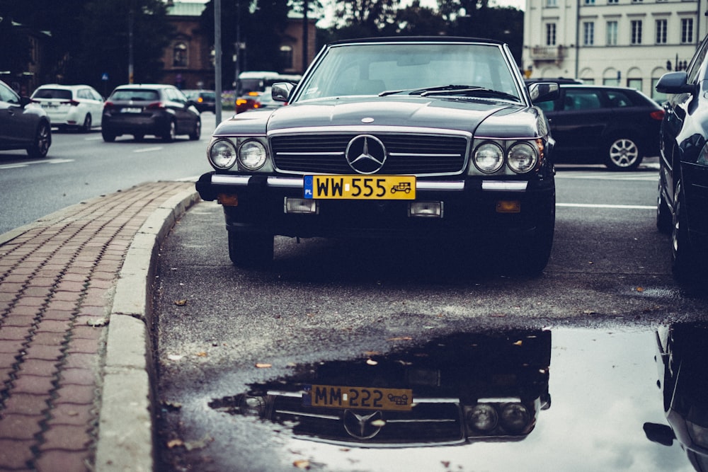 black Mercedes-Benz car on parking