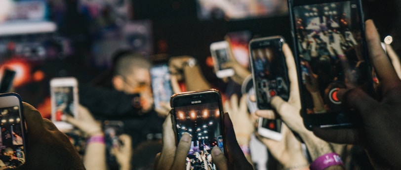 shallow focus photography of crowd taking video