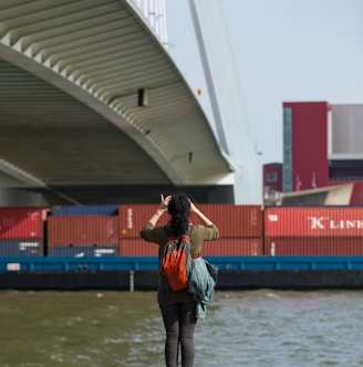 woman taking photo of bridge