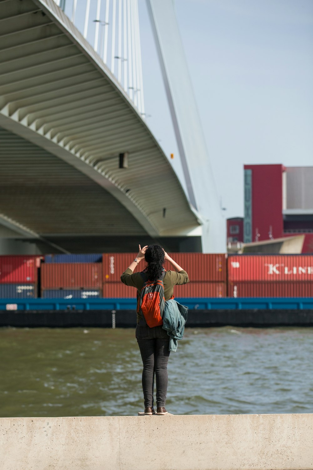 woman taking photo of bridge