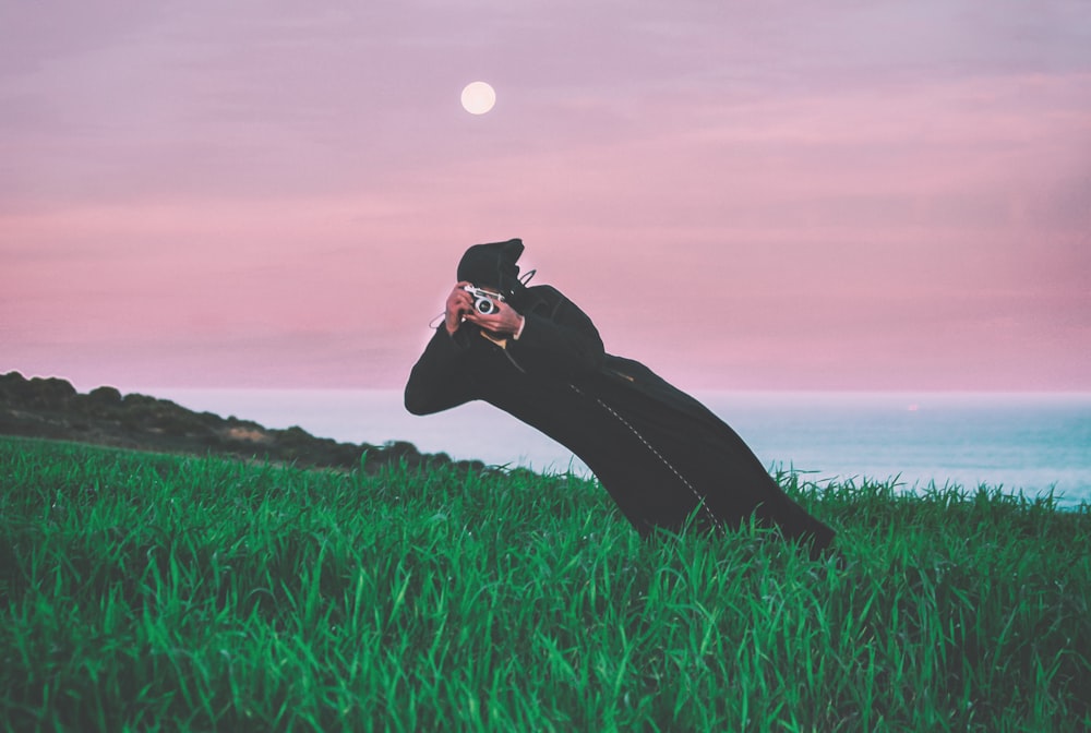 person talking photo in t he middle of grass field